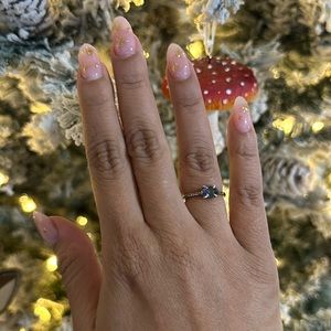 Sterling silver ring with multicolored centerpiece stone.